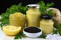 Melted ghee in glass jars with a lid and black caviar in a bowl on a background of parsley Royalty Free Stock Photo