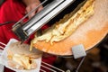 melted raclette cheese flows on a bread, food culture in switzerland