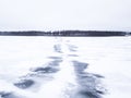 Melted snowmobile tracks on a frozen lake. Royalty Free Stock Photo