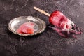 Melted strawberry ice cream popsicle lolly pops with whipped cream on gray background