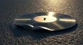 Melting Black Vinyl Record on Dark Surface in Warm Light Royalty Free Stock Photo