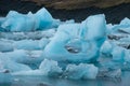 Melting blue ice formation with heart shape hole in Jokulsarlon glacier lagoon