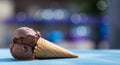 Melting Chocolate Ice Cream in Waffle Cone on Blue Surface Royalty Free Stock Photo