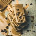 Melting coffee latte popsicles with roasted coffee beans