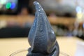Melting delicious bamboo charcoal vanilla soft serve ice cream Royalty Free Stock Photo