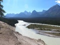 Melting glacier ice becomes a river with Canadian rockies in the background