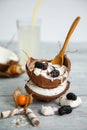 Meltingmelting ice cream in coconut shell, decorated with mulberry and physalis berries Royalty Free Stock Photo