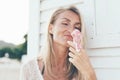 Melting ice cream in the cone flows between the hands of a young woman Royalty Free Stock Photo