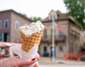 Melting ice cream cone, partially eatin in hand of woman Royalty Free Stock Photo