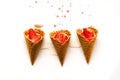 Melting ice cream in waffle cones with strawberries on white background. National ice cream day 19 july concept. Close-up Royalty Free Stock Photo