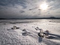 Melting ice crystals and icebergs. The beach covered by thick ice Royalty Free Stock Photo