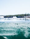 Melting ice crystals on surface of clear-watered lake Royalty Free Stock Photo