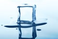 Melting ice cube with reflection isolated on white. Royalty Free Stock Photo