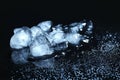 Melting ice cubes and water drops on black background. Royalty Free Stock Photo