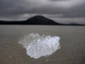 Melting ice floe flowing close shore. Structure of frozen bubbles