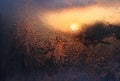 Melting ice, water drops and sunlight in a winter morning on glass Royalty Free Stock Photo