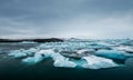 Melting ice on the water in Jokulsarlon lake in south Iceland in cloudy day. Global warming Royalty Free Stock Photo