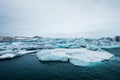 Melting ice on the water in Jokulsarlon lake in south Iceland in cloudy day. Global warming Royalty Free Stock Photo