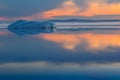 The melting iceberg on spring mountain lake in the setting sun. Royalty Free Stock Photo