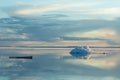 The melting iceberg on spring mountain lake in the setting sun. Royalty Free Stock Photo