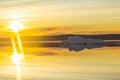 The melting iceberg on spring mountain lake in the setting sun. Royalty Free Stock Photo