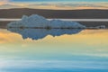 The melting iceberg on spring mountain lake in the setting sun. Royalty Free Stock Photo