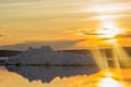 The melting iceberg on spring mountain lake in the setting sun. Royalty Free Stock Photo