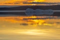 The melting iceberg on spring mountain lake in the setting sun. Royalty Free Stock Photo