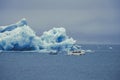 Melting icebergs in Iceland. Tourists in boats take a closer look. Royalty Free Stock Photo