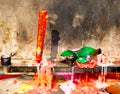 Melting joss sticks and candles Royalty Free Stock Photo