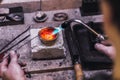 Melting precious metals in the crucible. Workflow in a jewelry workshop Royalty Free Stock Photo