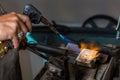 Melting Silver Grains in crucible with blowtorch Royalty Free Stock Photo