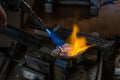 Melting a Silver Ingot in crucible with blowtorch;