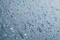 Melting snow and water drops on glass surface. Abstract blue tone background. Royalty Free Stock Photo