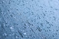 Melting snow and water drops on glass surface. Abstract blue tone background Royalty Free Stock Photo