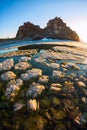 Melting spring ice of Lake Baikal, on the rock Shamanka at sunset