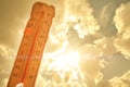 Melting street thermometer against bright summer sun.High temperature.Summer heat.Concept of global warming. Royalty Free Stock Photo