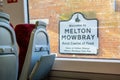 MELTON MOWBRAY, ENGLAND- 3 April 2021: Welcome to MELTON MOWBRAY sign viewed from the inside of a train