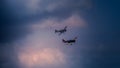 Evolution of two old aircraft in a stormy sky