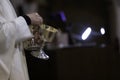 A member of the clergy holds the communion cups Royalty Free Stock Photo