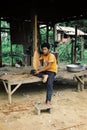 member of the local dragon boat team preparing for the competition by carving his own paddle Royalty Free Stock Photo