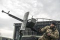 Member of the mobile air defence group checks a DShK machine gun atop of a pick up truck in the Hostomel town, Ukraine Royalty Free Stock Photo