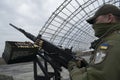 Member of the mobile air defence group checks M2 Browning machine gun atop of a pick up truck in Hostomel town, Ukraine Royalty Free Stock Photo