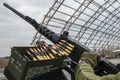 Member of the mobile air defence group checks M2 Browning machine gun atop of a pick up truck in Hostomel town, Ukraine Royalty Free Stock Photo