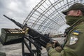 Member of the mobile air defence group checks M2 Browning machine gun atop of a pick up truck in Hostomel town, Ukraine Royalty Free Stock Photo