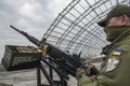 Member of the mobile air defence group checks M2 Browning machine gun atop of a pick up truck in Hostomel town, Ukraine Royalty Free Stock Photo