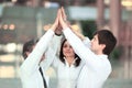 Members of the business team giving each other a high-five,standing in the office Royalty Free Stock Photo