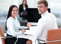 Members of the business team sitting at Desk and looking at camera . Royalty Free Stock Photo