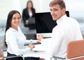 Members of the business team sitting at Desk and looking at camera . Royalty Free Stock Photo