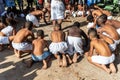 Members of the cultural event Nego Fugido sing and sit on the ground for the end of slavery in Acupe